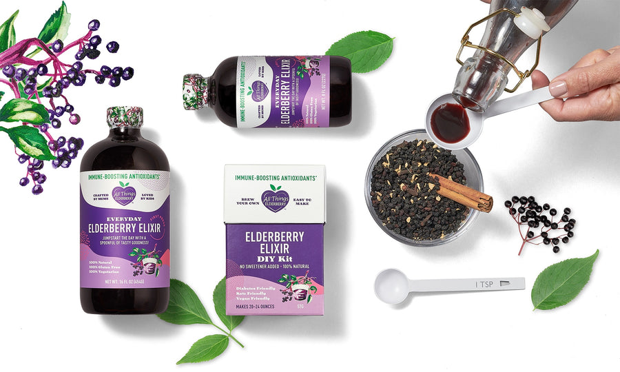 Flat lay of All Things Elderberry elixir bottles, DIY kit, dried elderberries, cinnamon stick, and pouring spoon – organic immune support products.